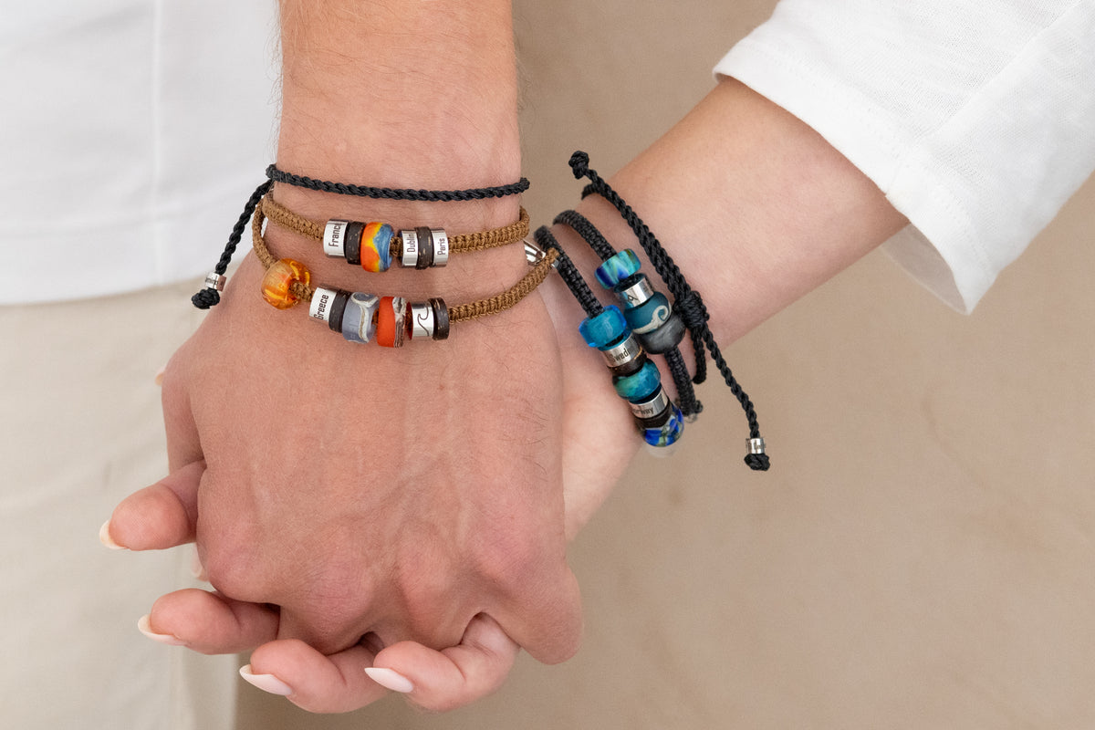 El Camino Black Journey Bracelets being worn with other El Camino Bracelets. The perfect gift for anyone who loves to travel.