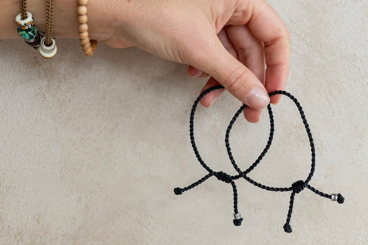 Two Black El Camino Journey Bracelets. The perfect friendship bracelet to gift to your travel partner. Worn alongside an El Camino Travel Bracelet.