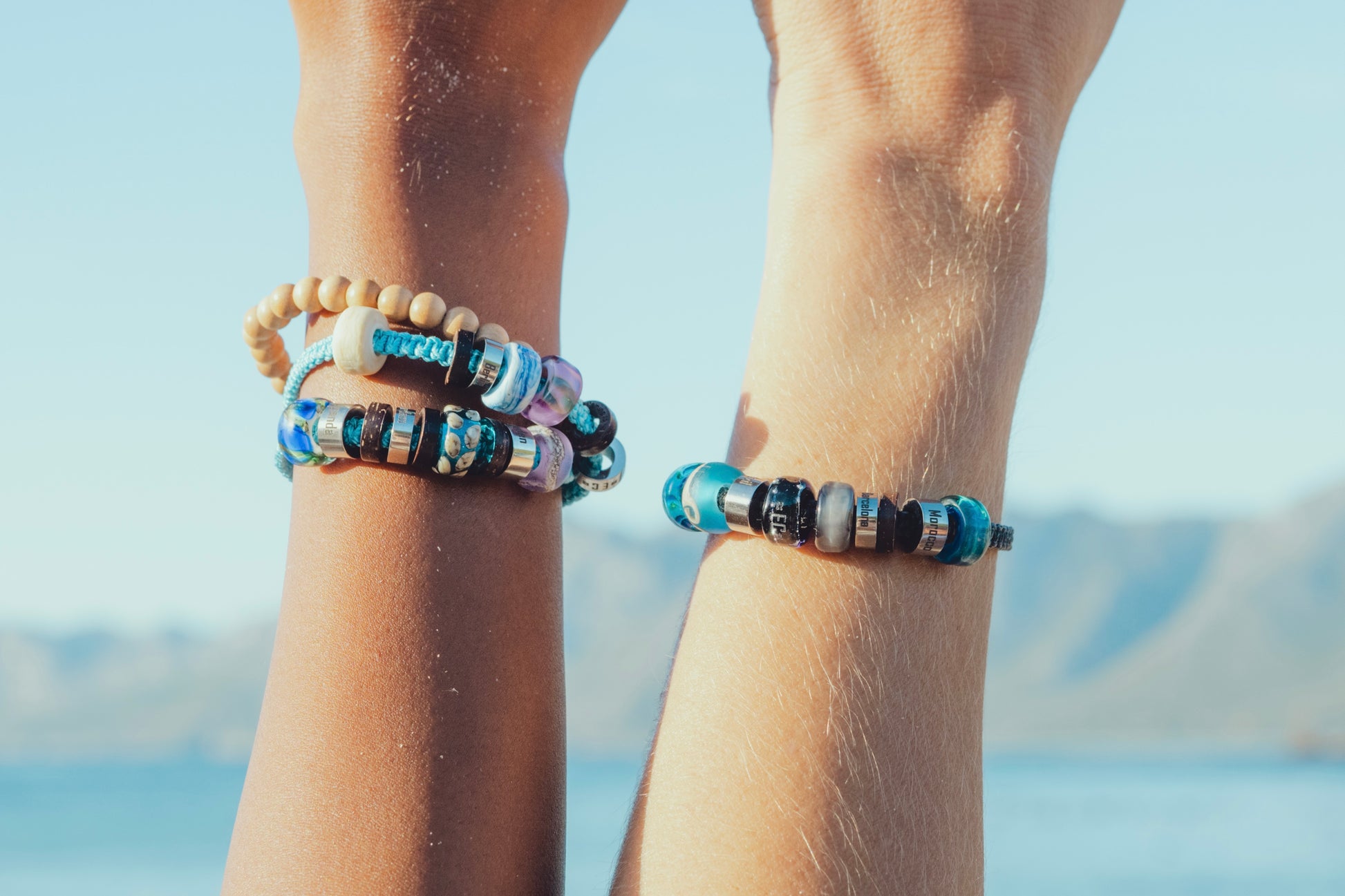 El Camino travel bracelets with Pink Northern Lights, Turtle, Baltic Sea, Pacific Ocean, Starry Sky, Morocco and Blue Northern Lights charms Steps memory beads.